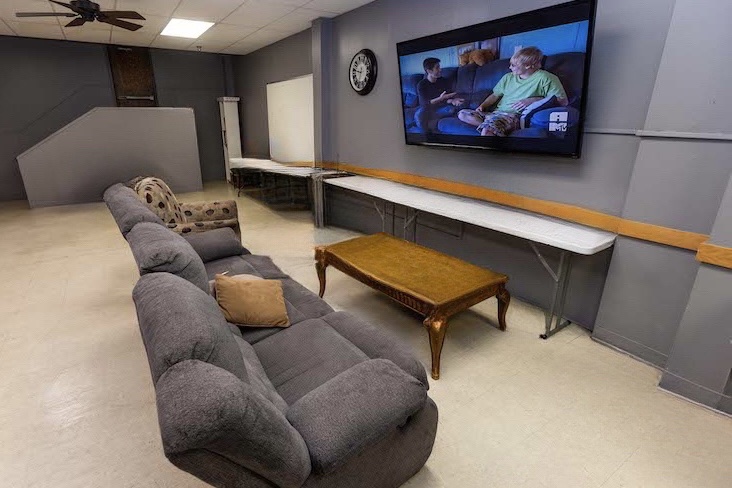 Lounge with couches and large TV screen
