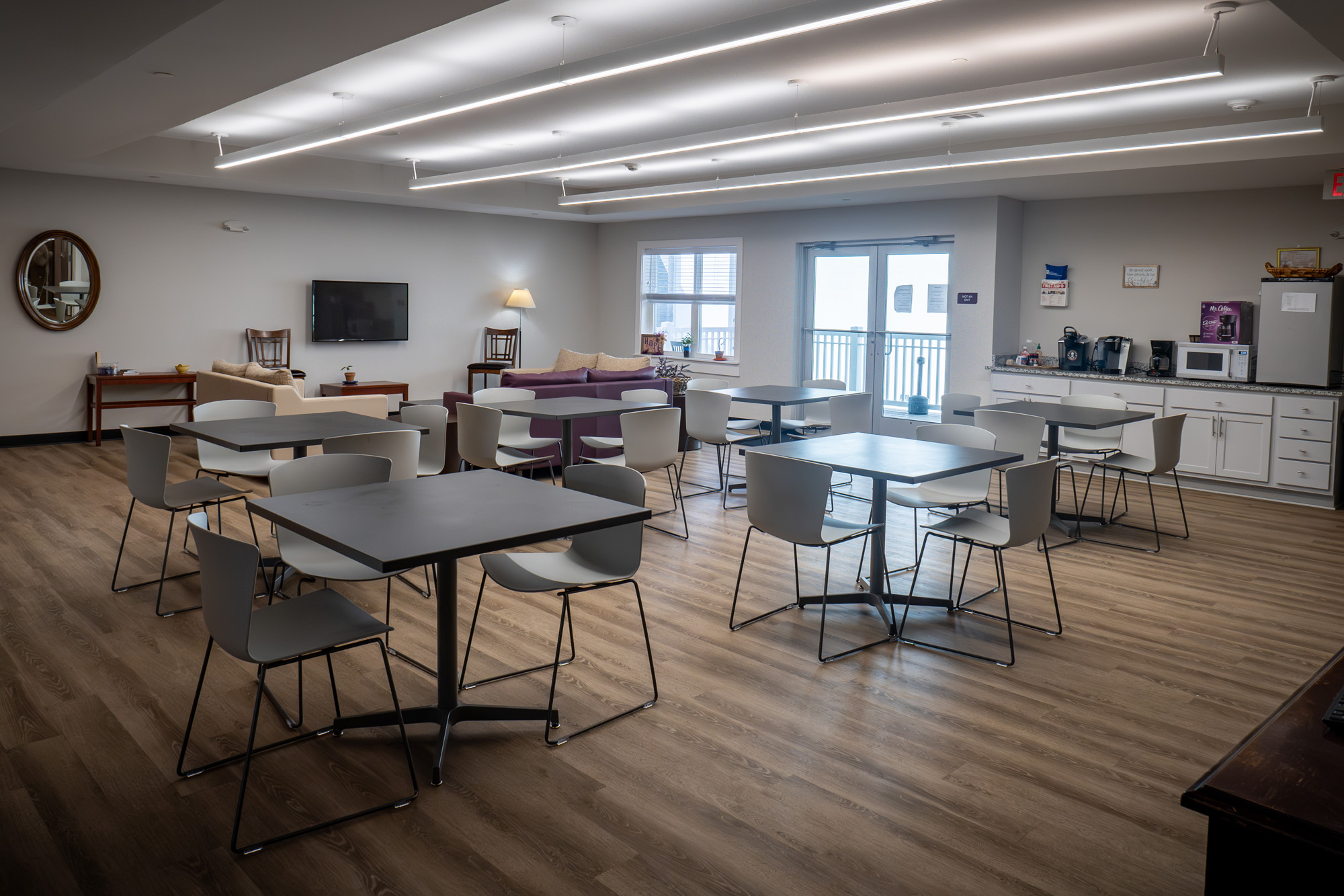Modern kitchen with granite countertop, stainless appliances, and sitting area