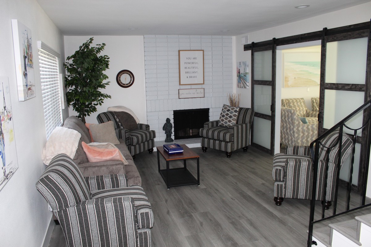 Living room with striped chairs and fireplace