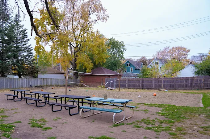 Fenced yard with picnic tables and open space