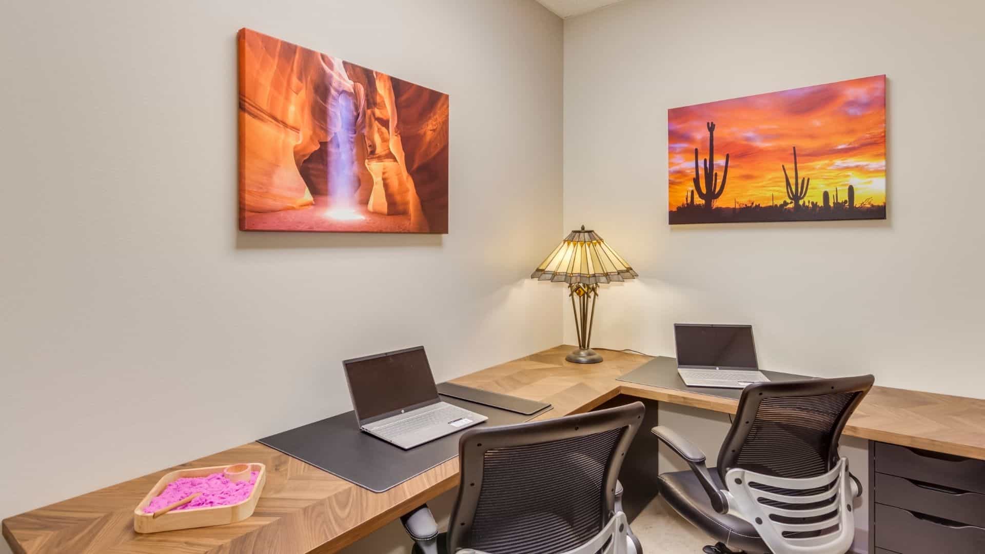 Office space with seating and a l-shaped desk.
