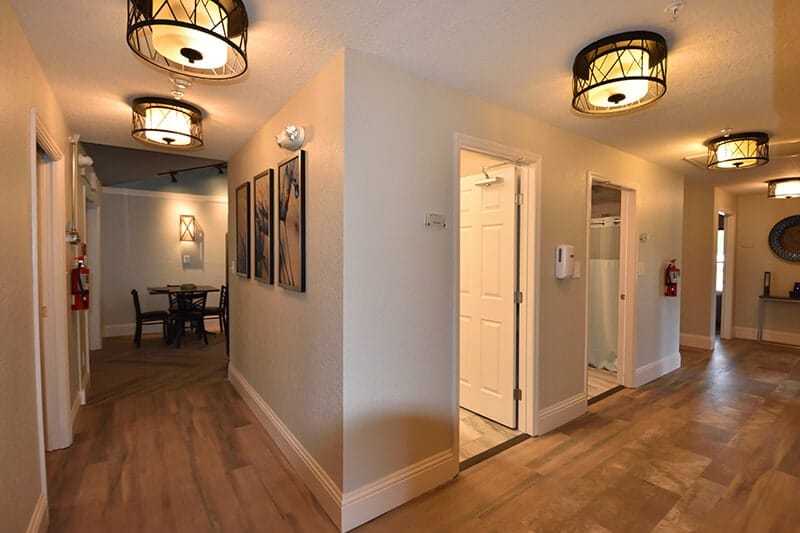 Bright hallway with wood floors and elegant lighting