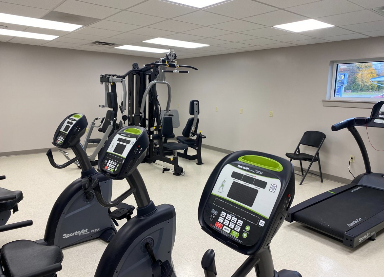 Exercise room with cardio equipment and weight station