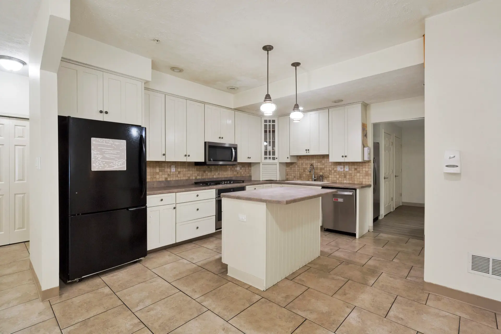 Residential kitchen with island, appliances, and cabinet space