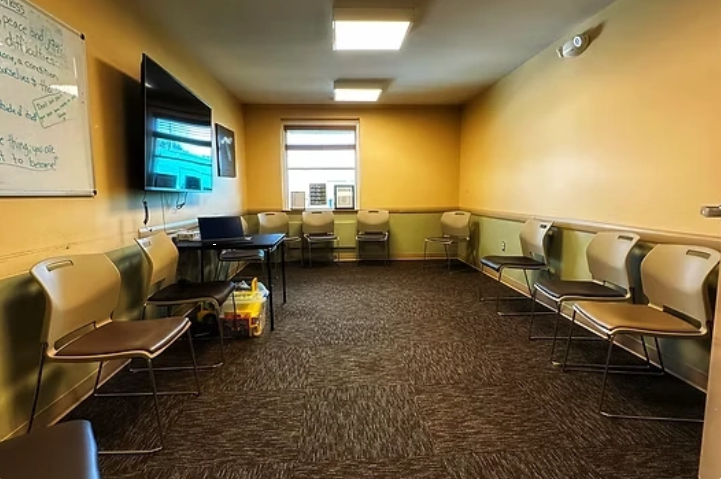 Therapy room with chairs arranged along the walls
