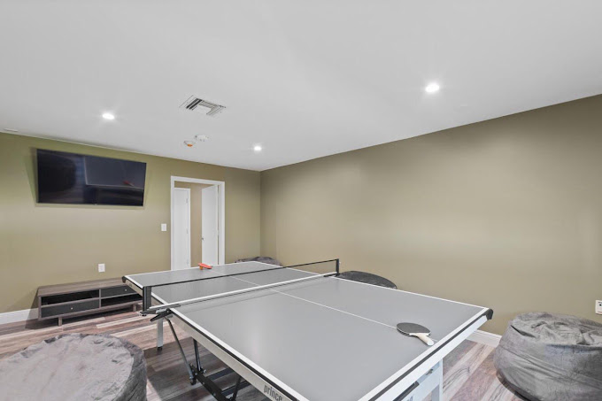 Ping pong table with bean bags and wall-mounted TV