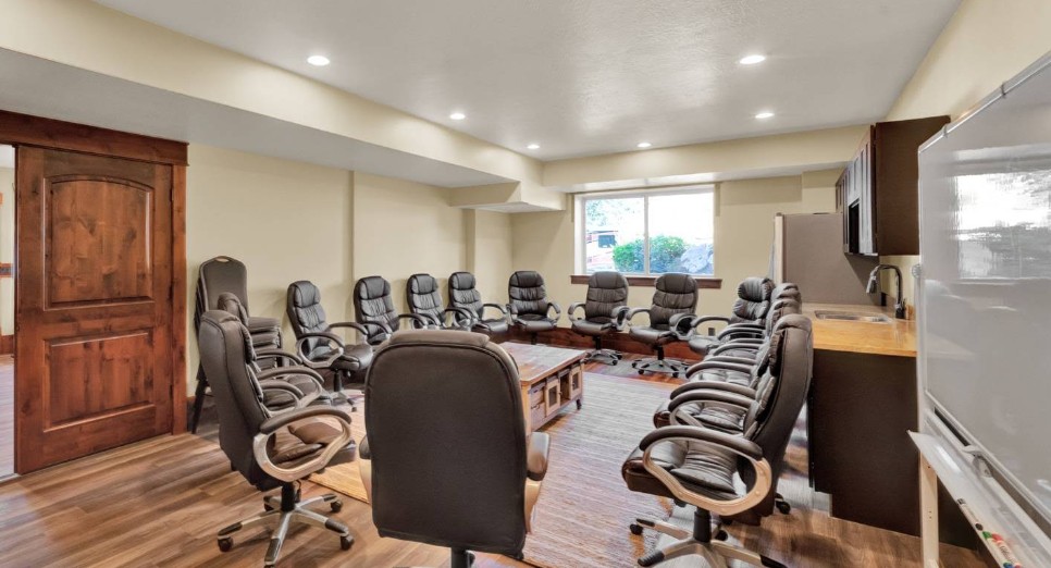 Group therapy room with circle seating and kitchenette