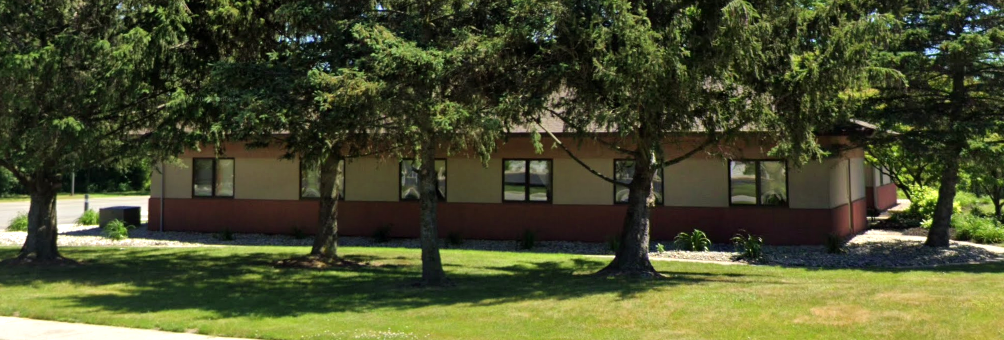 Rehab center exterior surrounded by tall trees