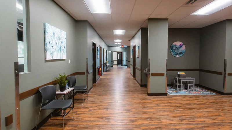 Wide hallway with seating inside rehab facility