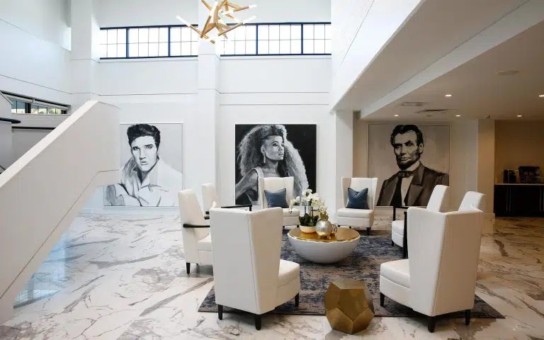 Grand lobby with high ceilings and celebrity portraits.