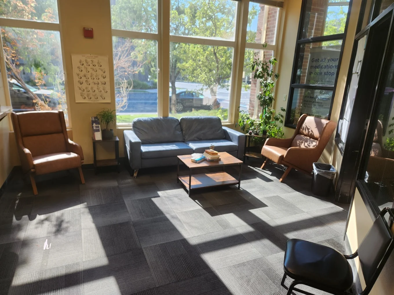 Rehab waiting lounge with large windows and cozy seating