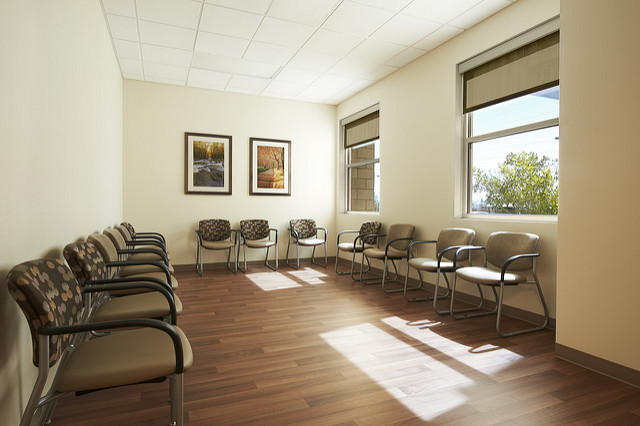  Sunlit waiting room with rows of chairs and framed art