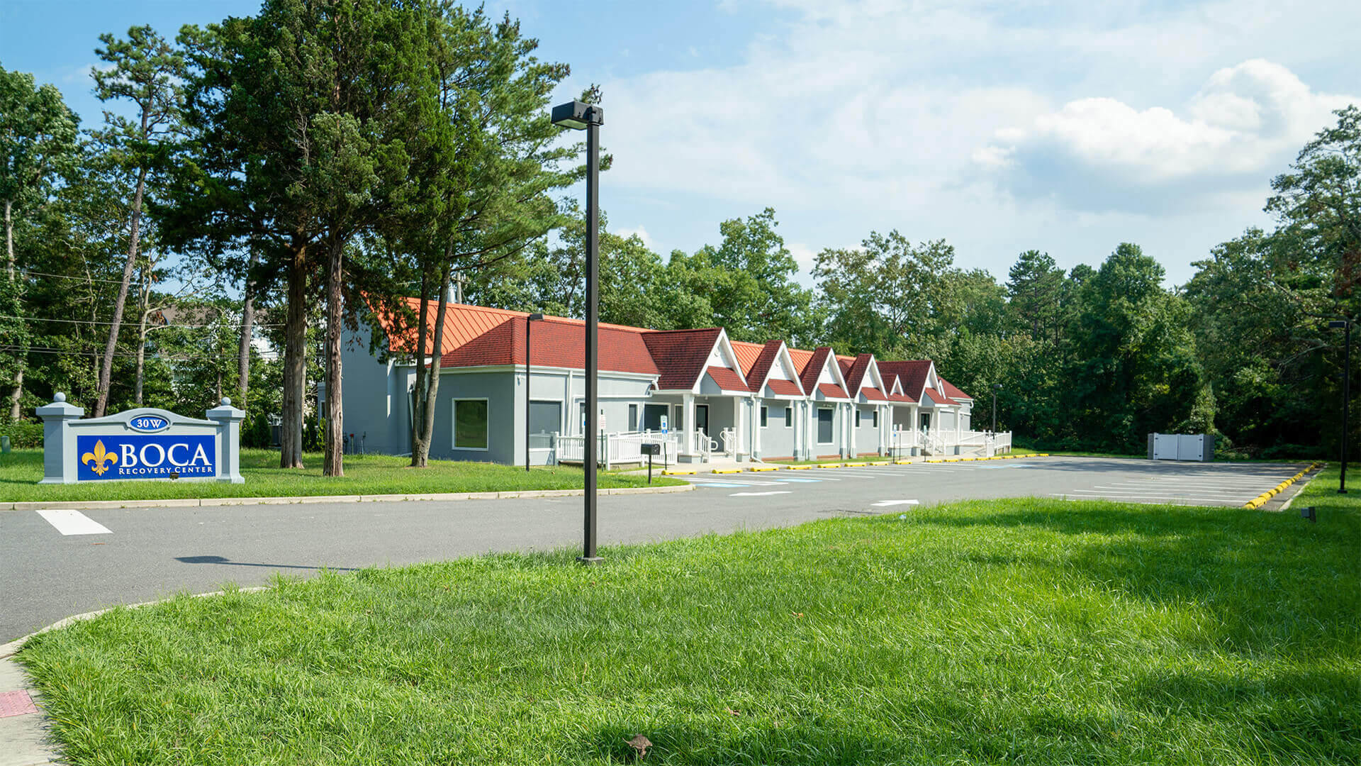 Facility exterior with buildings, parking and signage.