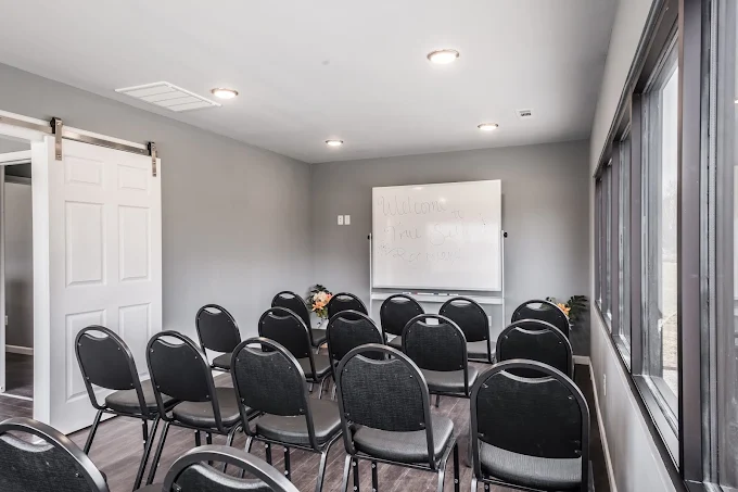 Group therapy room with chairs and whiteboard