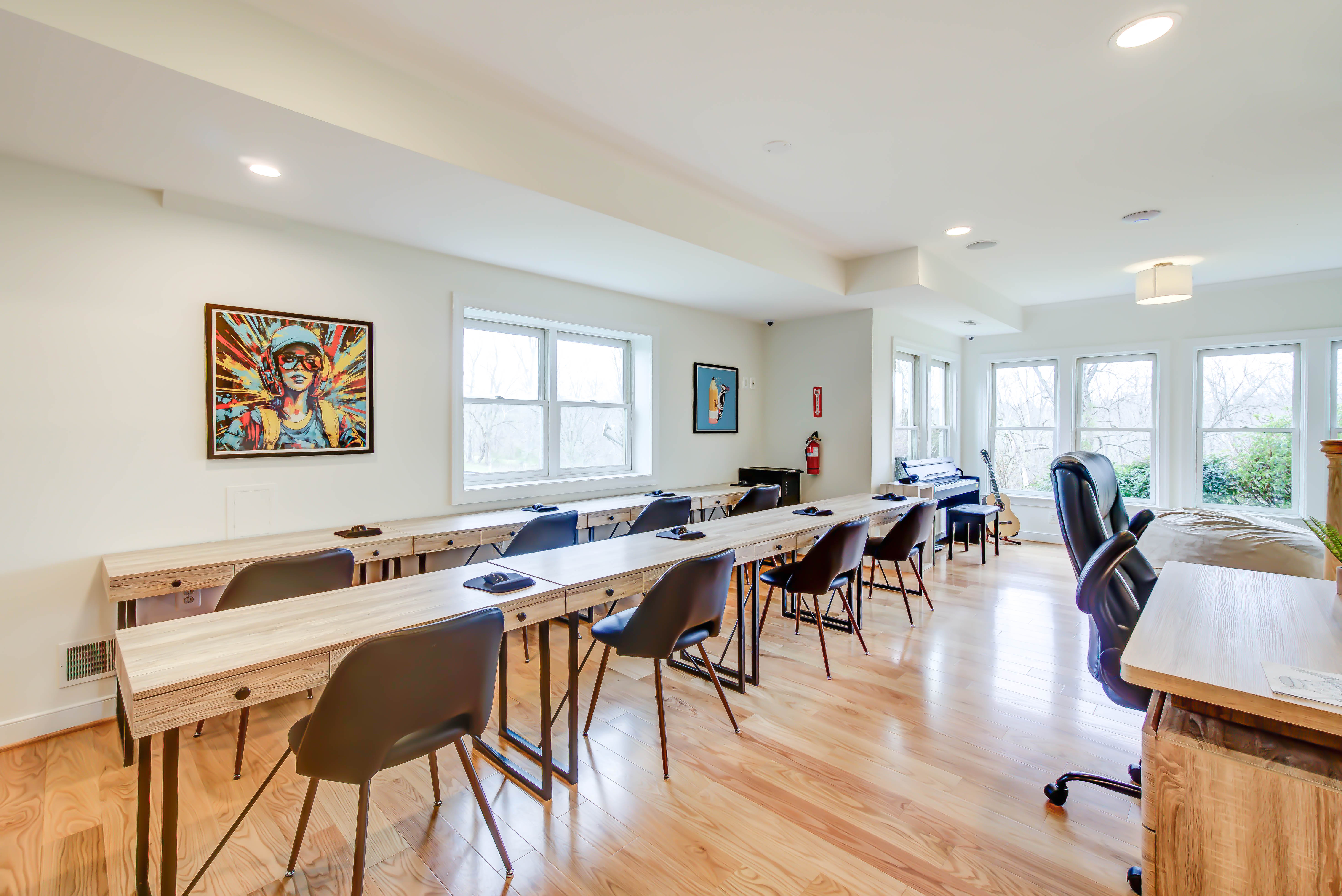 Classroom-style group room with desks and bright windows
