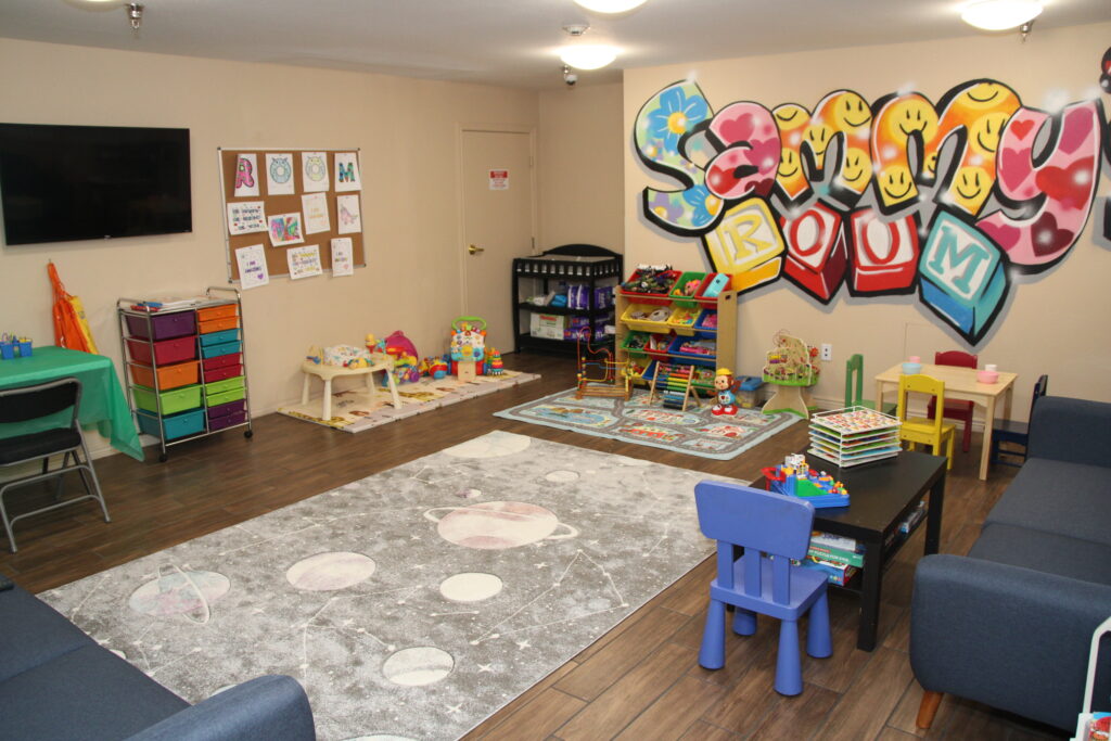     Colorful playroom with toys, games, and art on the walls