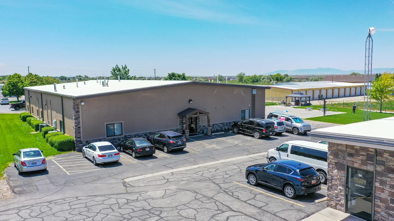 Residential treatment facility building with parking lot and green grounds