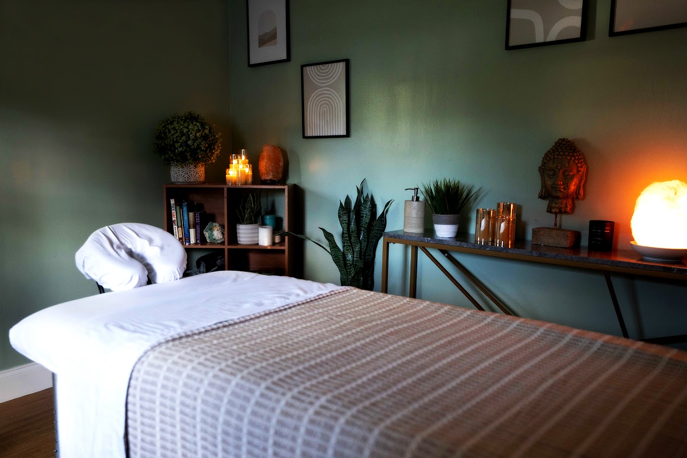 Massage room with a table, candles and decor,