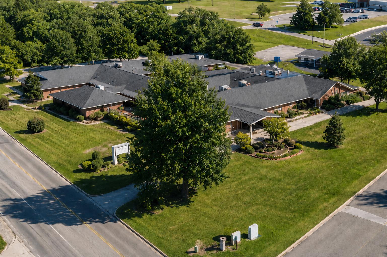 Aerial view of facility buildings surrounded by lawns and trees