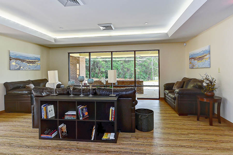 Open lounge area with leather sofas and large sliding doors.