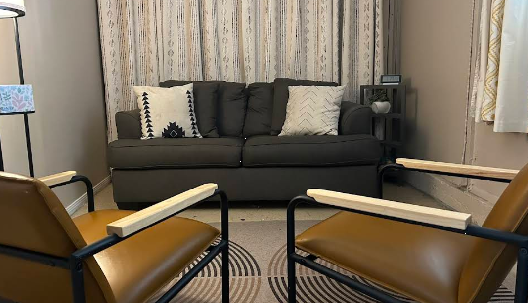 Therapy room with sofa, two chairs, and patterned curtain