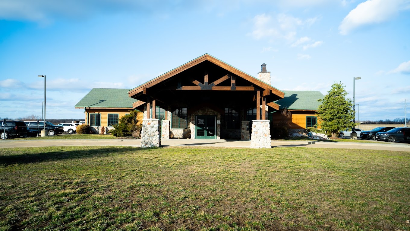 Rehab facility with a rustic lodge-style exterior and stone pillars.