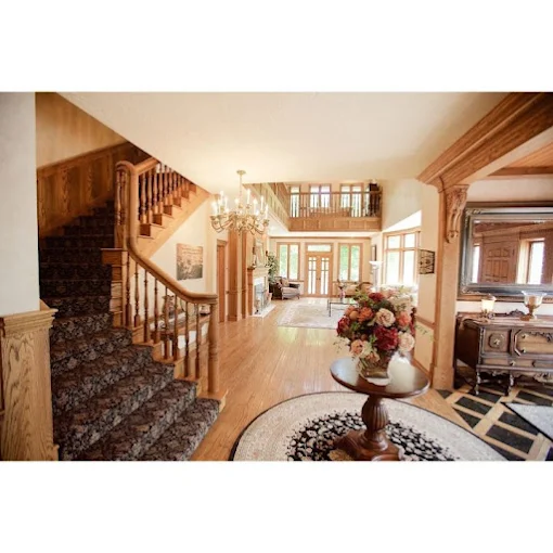 Open foyer with chandelier and curved wood staircase