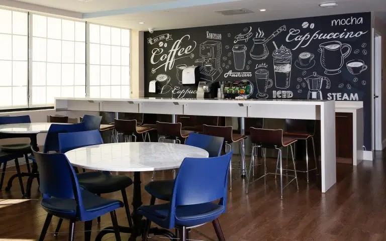 Coffee bar with chalkboard menu and casual seating.