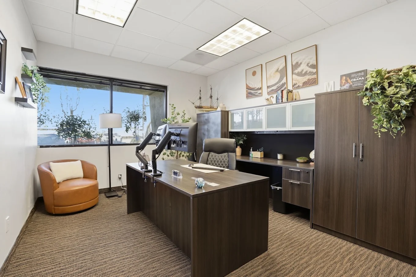 Private office with desk, guest chair, and large window