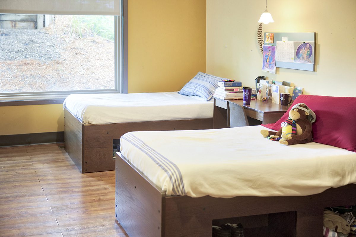 Shared bedroom with twin beds and large window view