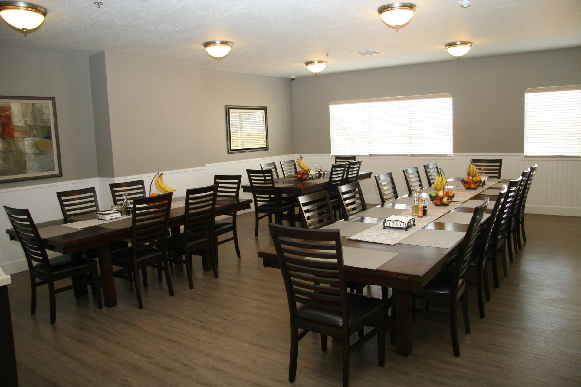 Dining room with long tables and chairs set for meals