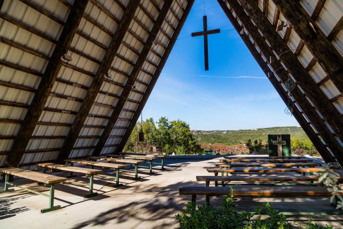 Open-air chapel with cross and scenic hill views