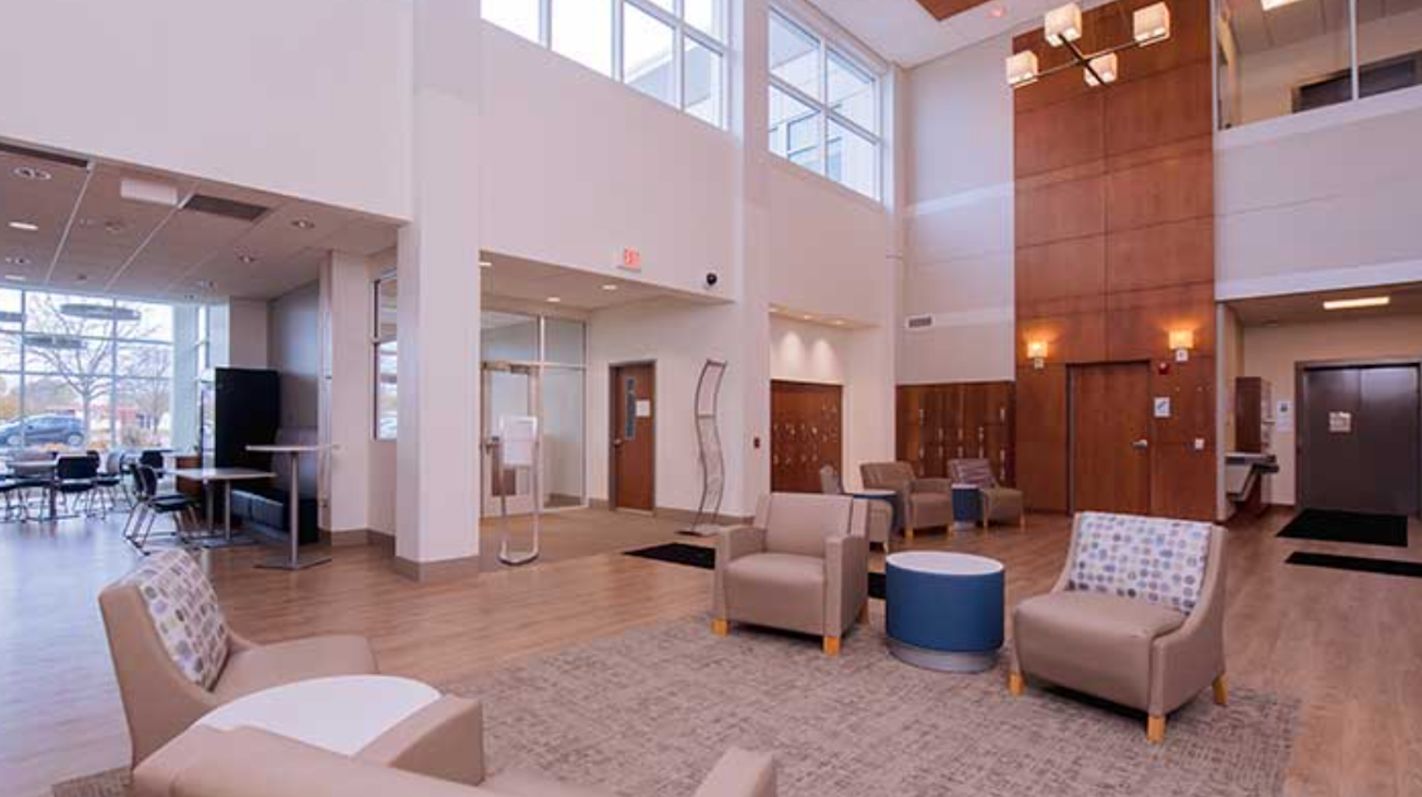 Spacious lobby with chairs and tall windows