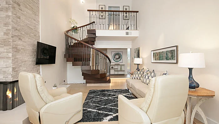 Spacious living room with fireplace and staircase