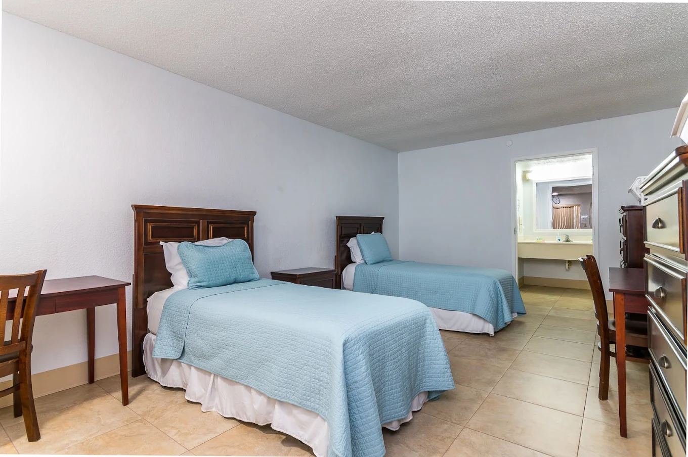Shared bedroom with two twin beds and light blue bedding.
