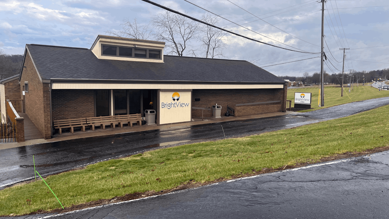 Exterior of BrightView Health in Lancaster, Ohio, showing the brick treatment center, covered entrance, BrightView signage, benches, driveway, and grassy roadside
