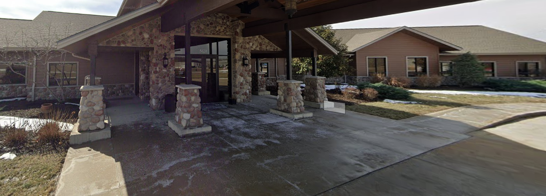Covered stone entryway leading into facility building