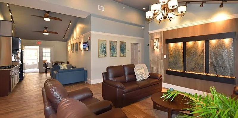 Open lounge with leather sofas and wall fountain
