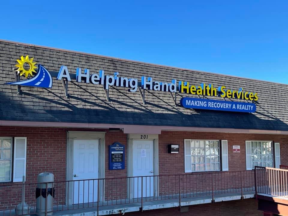 Brick building facade with clinic signage and double-door entrance