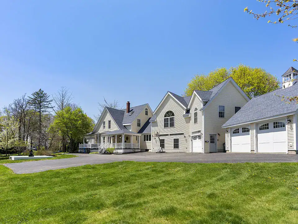 Exterior view of Southern Maine Recovery residential treatment campus with wraparound porch and detached garage