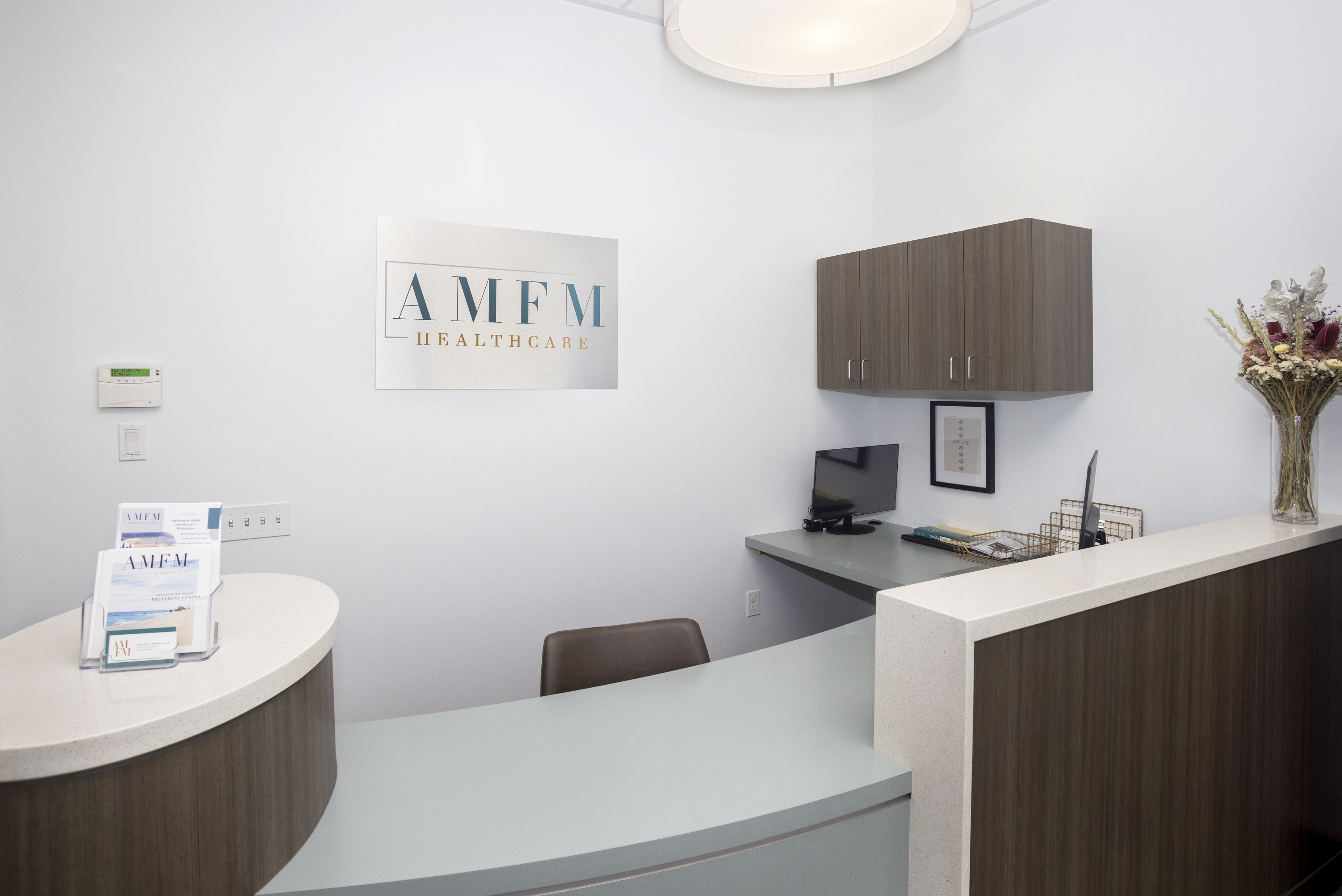 Modern front desk with AMFM Healthcare sign