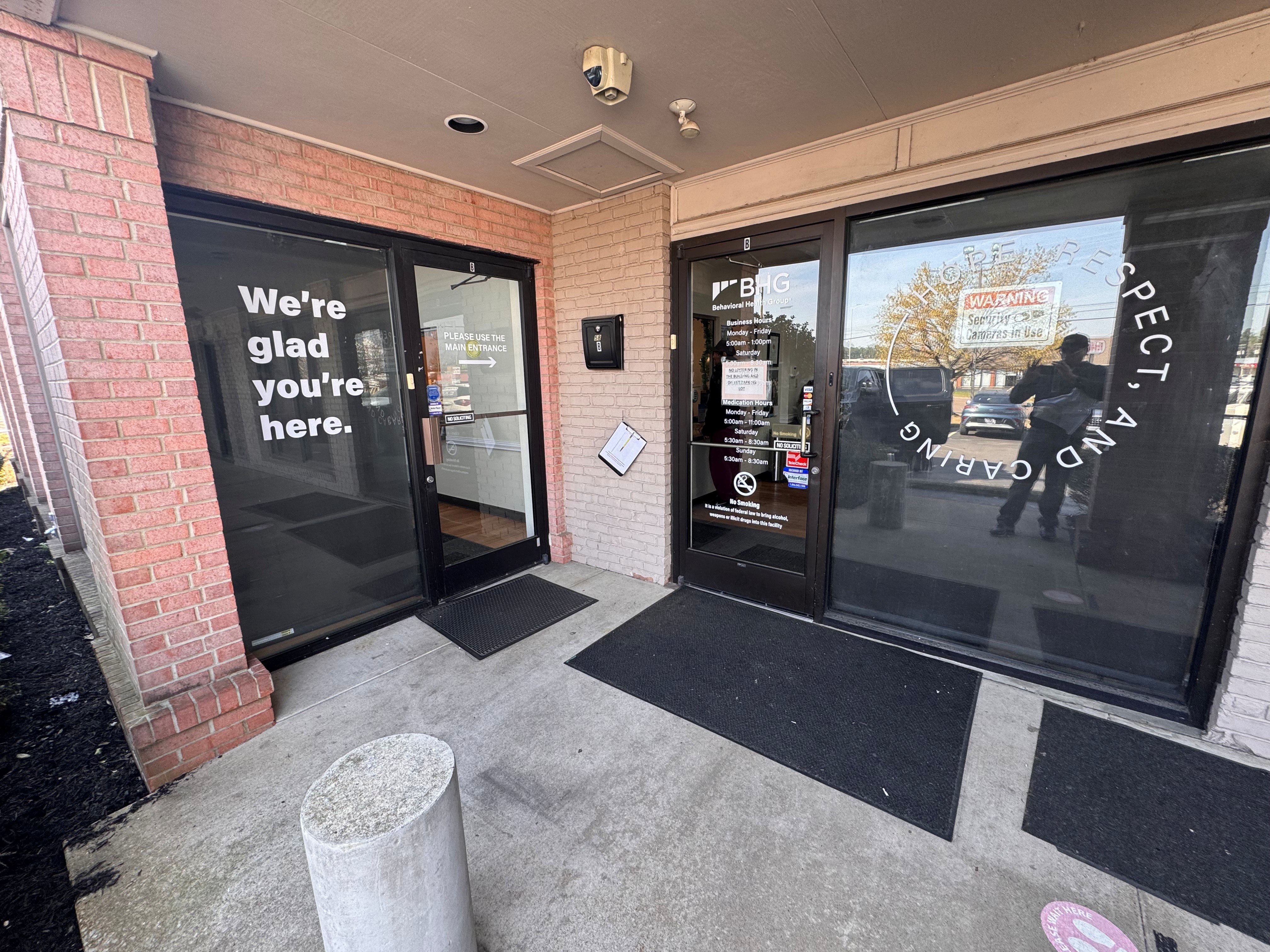 Covered entrance with BHG branding and welcome window decals