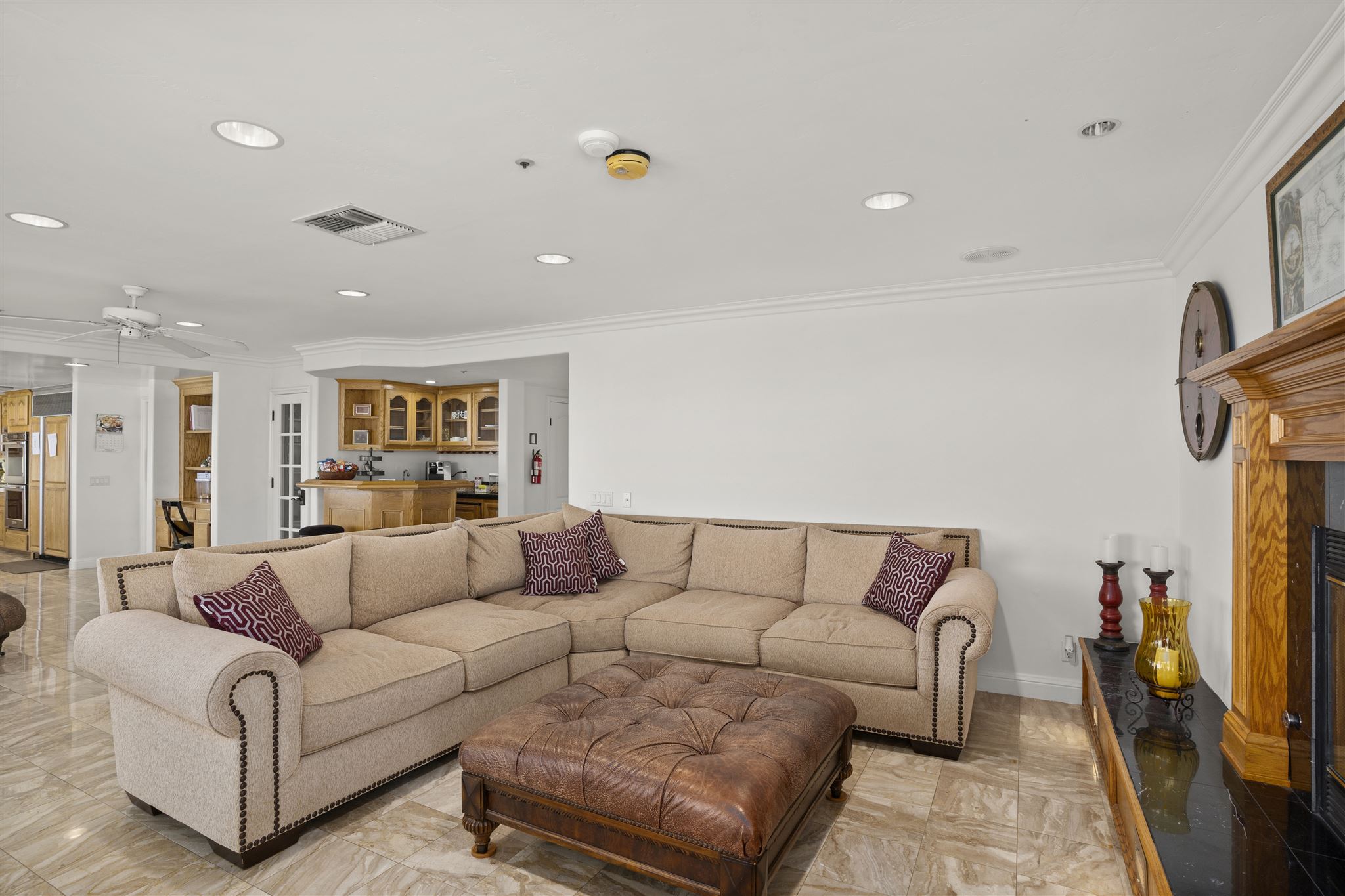 Open living space with a large sectional sofa and wooden fireplace.
