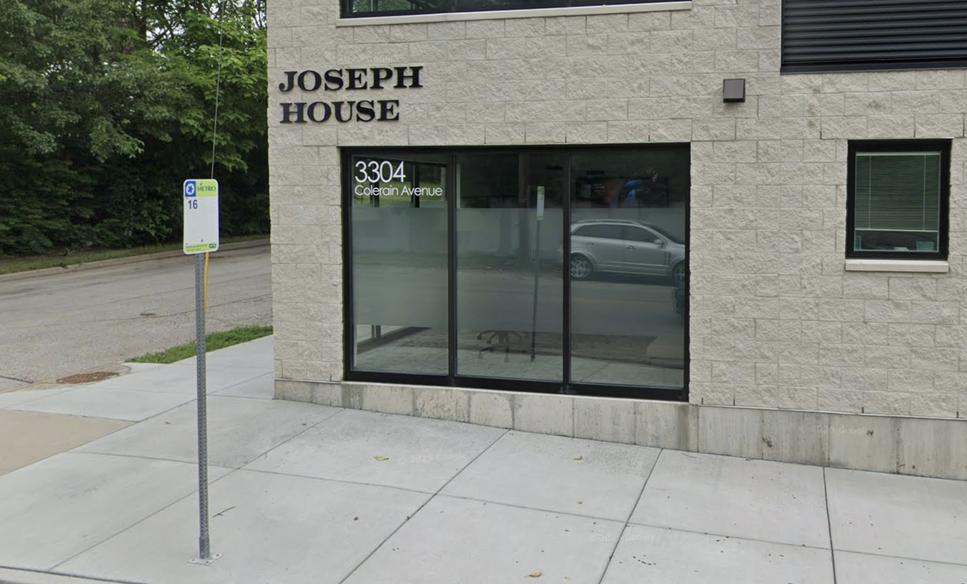 Joseph House entrance with glass windows and sidewalk