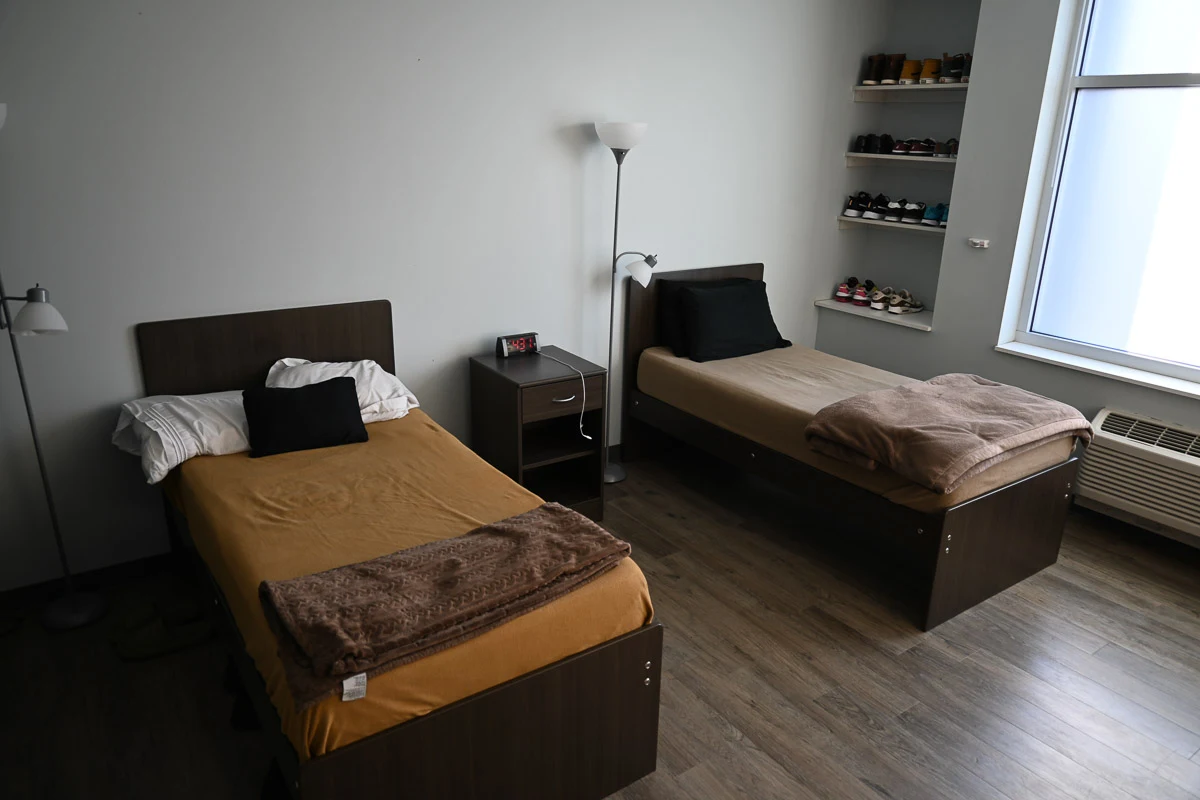 Shared bedroom with two single beds and a window
