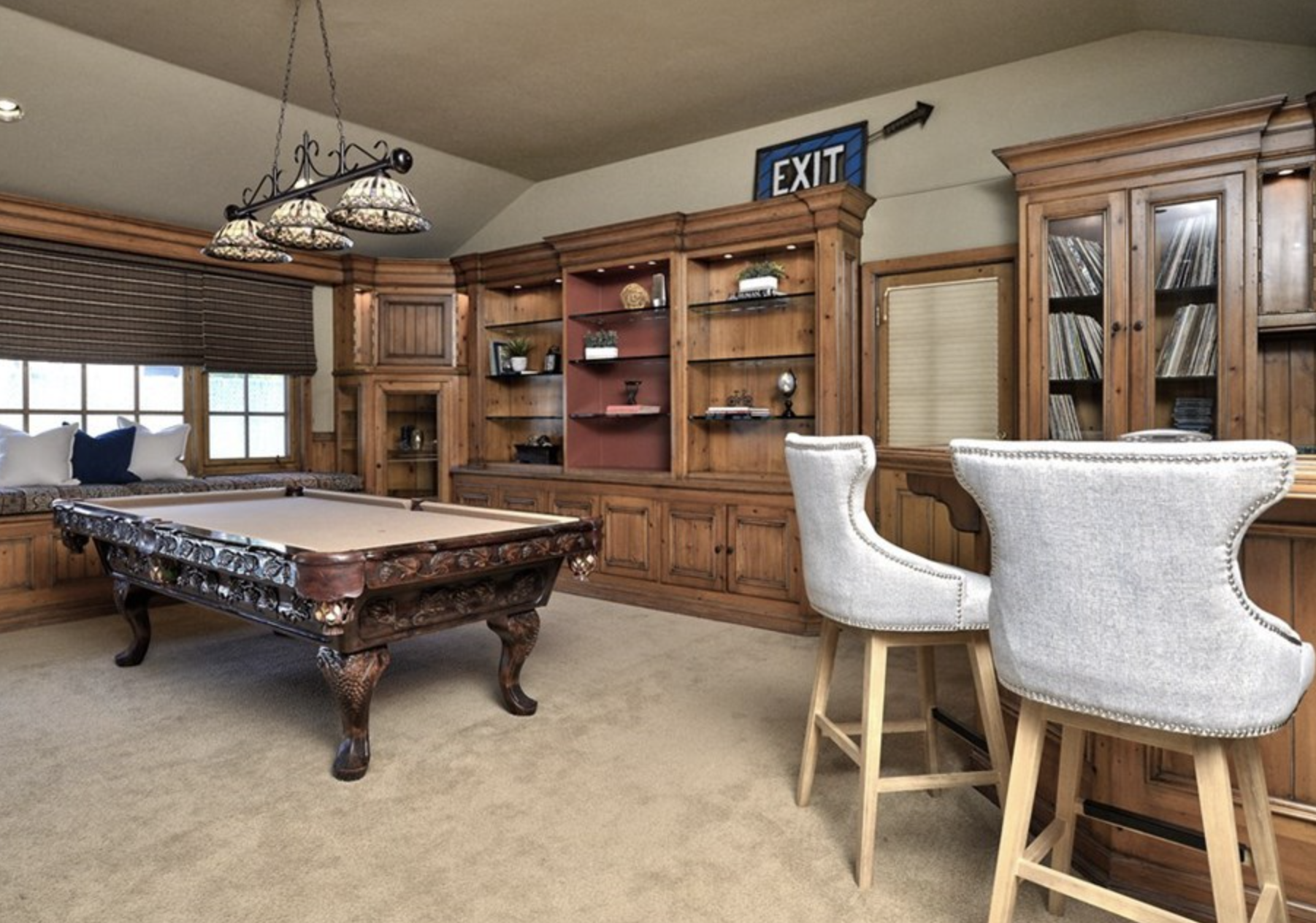 Common room with a pool table and plush seating.