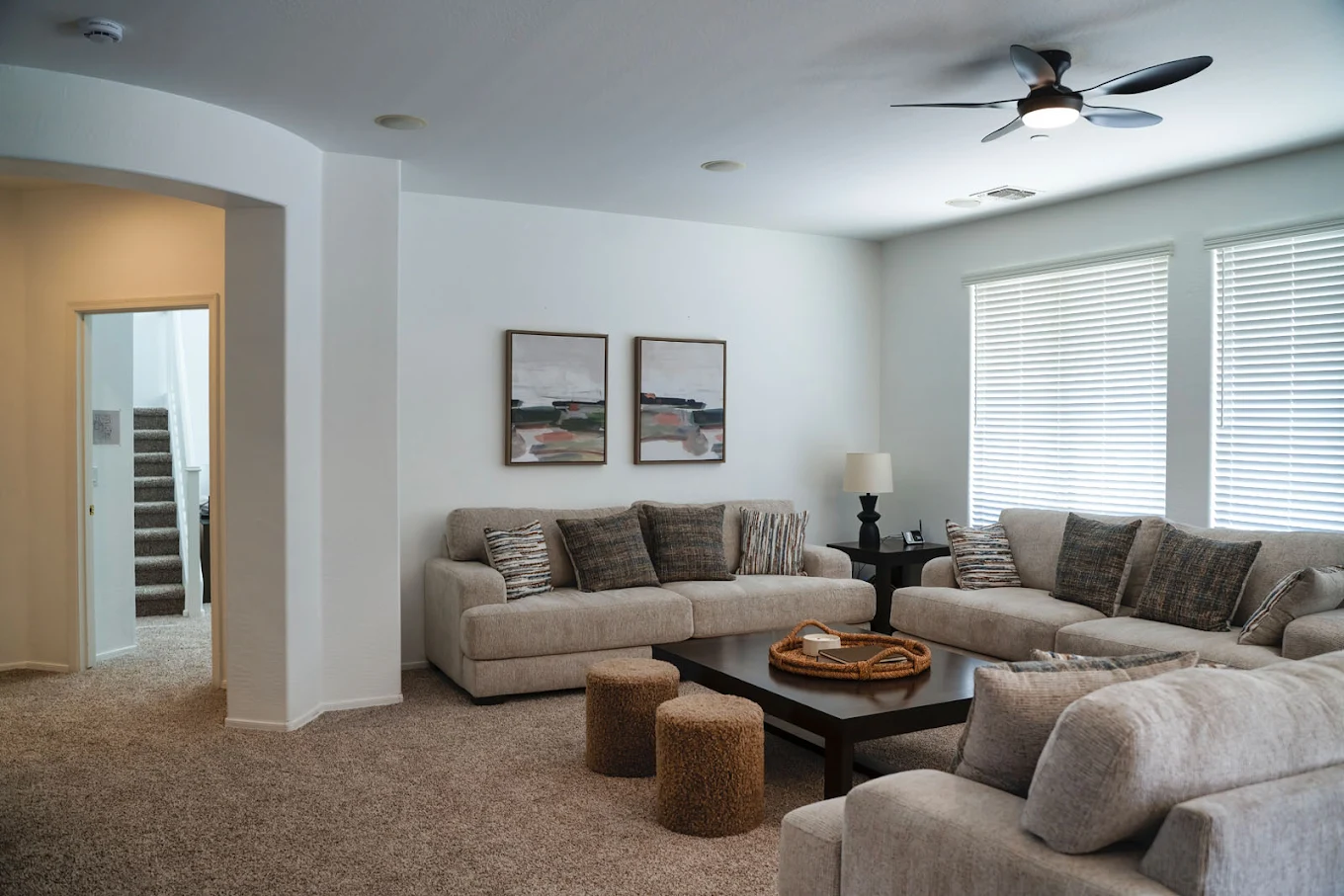 Bright lounge with sofas, windows, and central table
