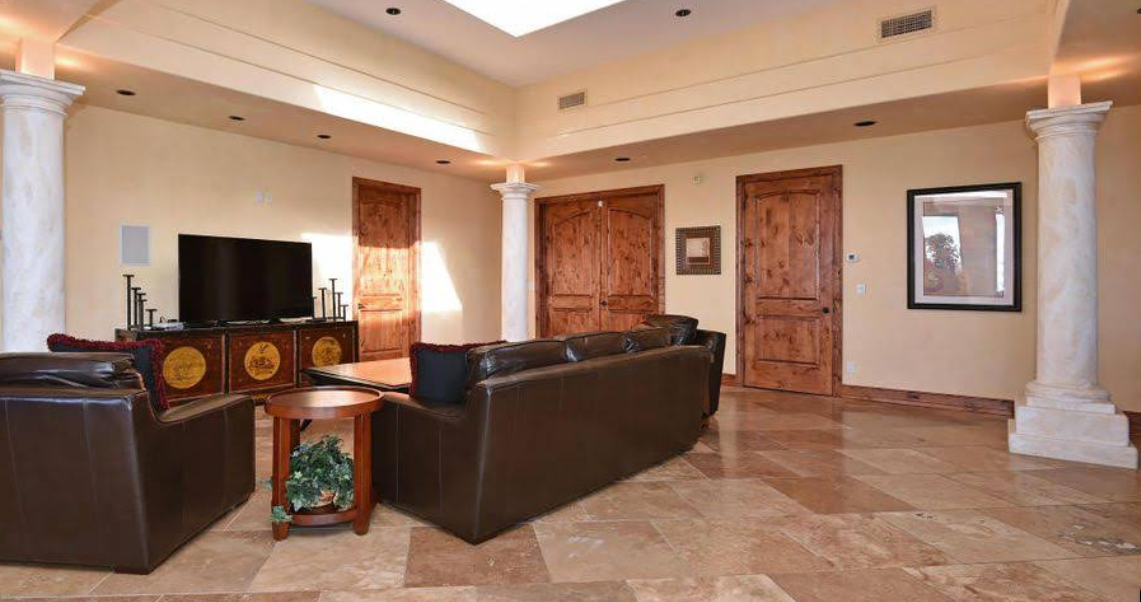 Living room with leather seating and TV entertainment area