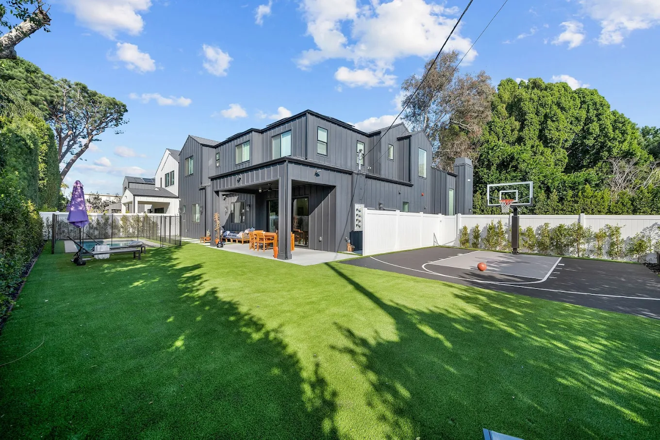 Backyard with basketball court and outdoor seating