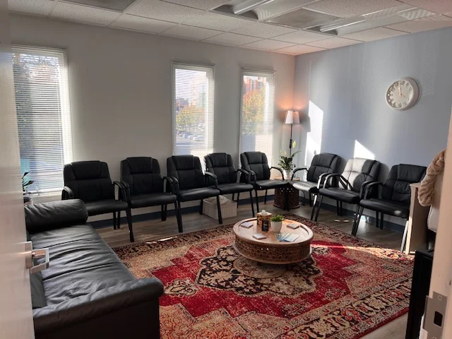Group therapy room with chairs arranged in a circle and natural light